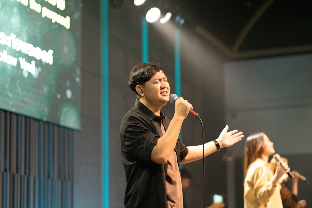 man singing on stage