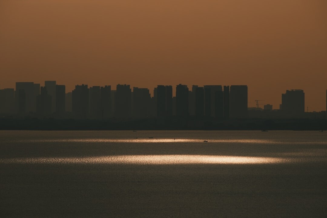 City skyline at golden hour with warm light over buildings